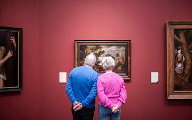 Visitors viewing artwork at Groeningemuseum, Bruges.
