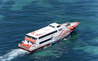 Ferry cruising on clear blue waters during Rottnest Island day trip from Fremantle.