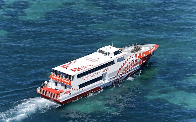 Ferry cruising on clear blue waters during Rottnest Island day trip from Fremantle.