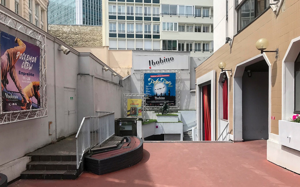 Bobino Theatre entrance with posters in Montparnasse, Paris, on a walking tour.