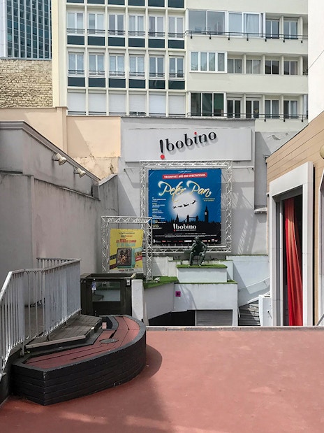 Bobino Theatre entrance with posters in Montparnasse, Paris, on a walking tour.