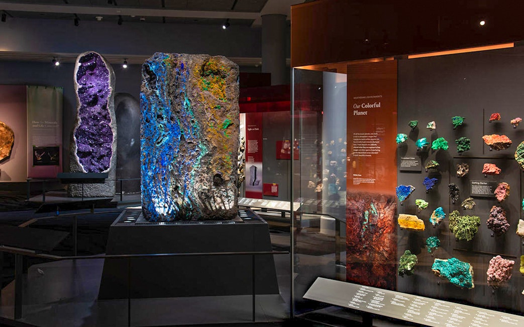 Colorful mineral displays at Migone Hall of Gems, showcasing vibrant geological formations.