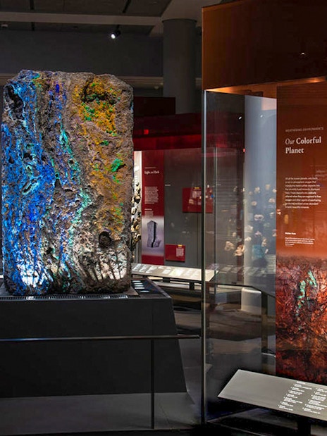 Colorful mineral displays at Migone Hall of Gems, showcasing vibrant geological formations.
