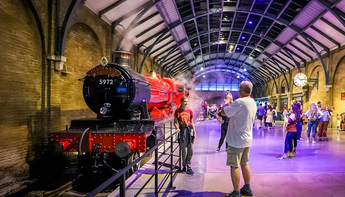 Tourists photographing the Hogwarts Express at Warner Bros. Studio, London.