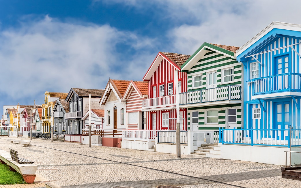 Colorful striped houses in Costa Nova, Aveiro, Portugal, seen on a guided tour.