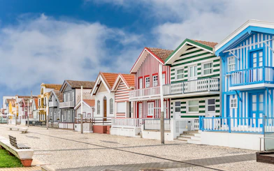 Colorful striped houses in Costa Nova, Aveiro, Portugal, seen on a guided tour.