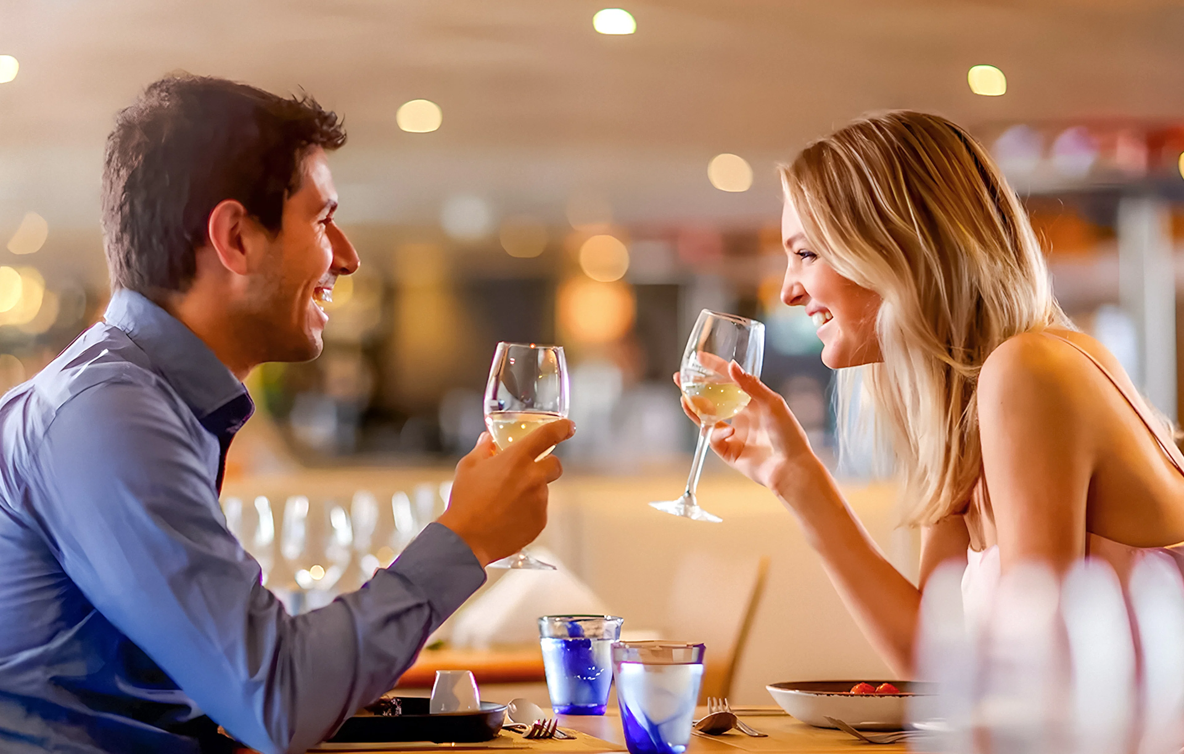 Couple toasting with wine on Starlight Dinner Cruise in Sydney.