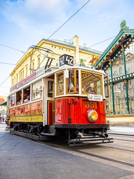 Prague historical tram on Line 42 passing through city streets, part of 24-hour hop-on hop-off tour.