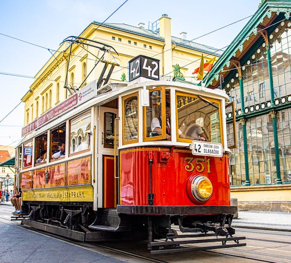 Prague historical tram on Line 42 passing through city streets, part of 24-hour hop-on hop-off tour.