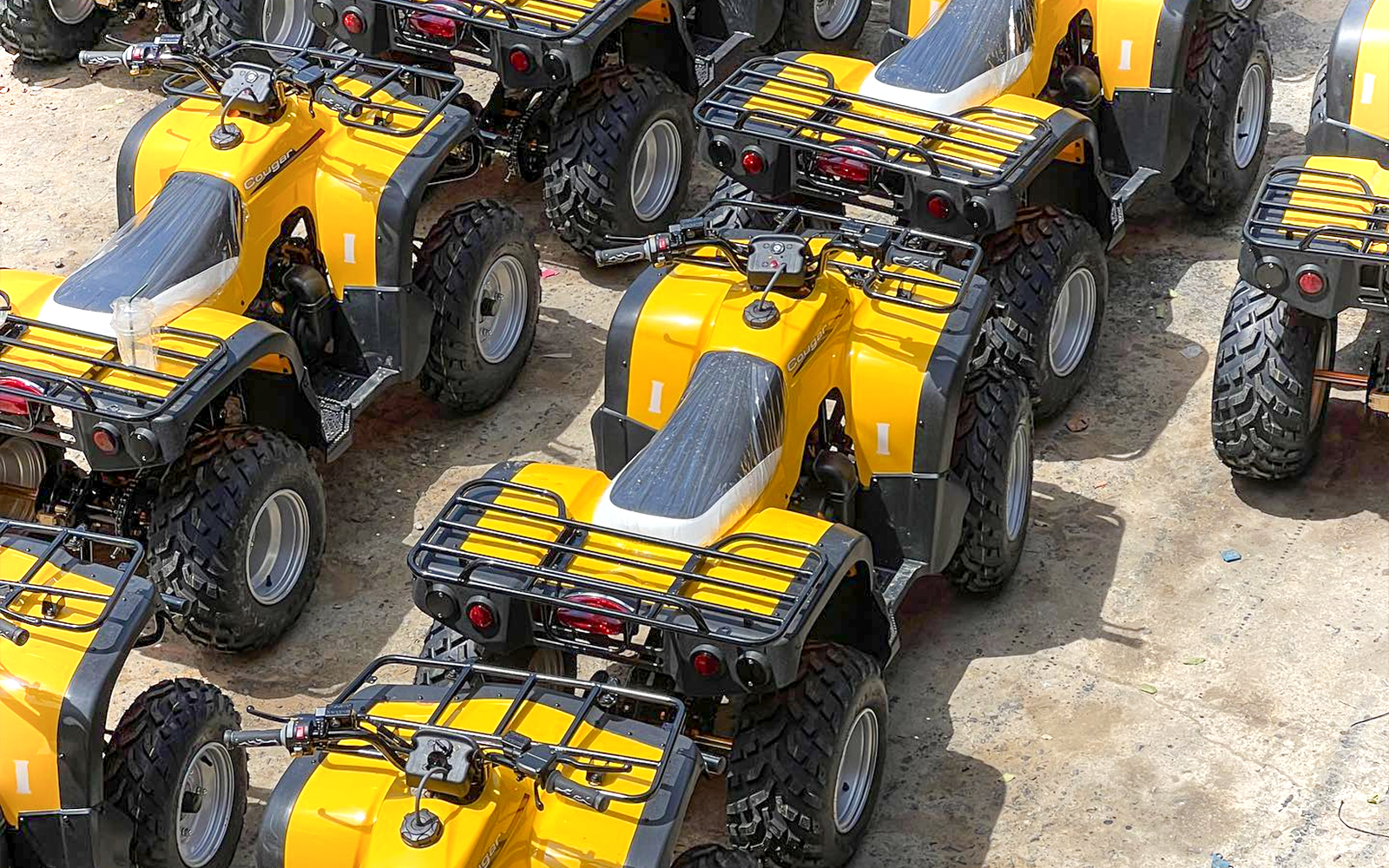 Yellow ATVs lined up for Phuket adventure tour with zipline experience.