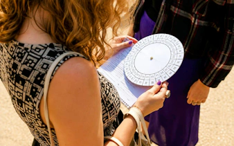 Person holding a cipher wheel during a treasure hunt tour from the Panthéon to the Louvre.