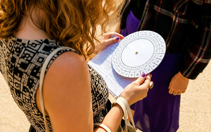 Person holding a cipher wheel during a treasure hunt tour from the Panthéon to the Louvre.