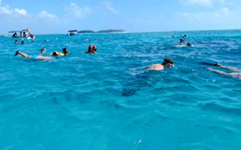 Snorkelers exploring clear waters during a fishing adventure in Zanzibar.