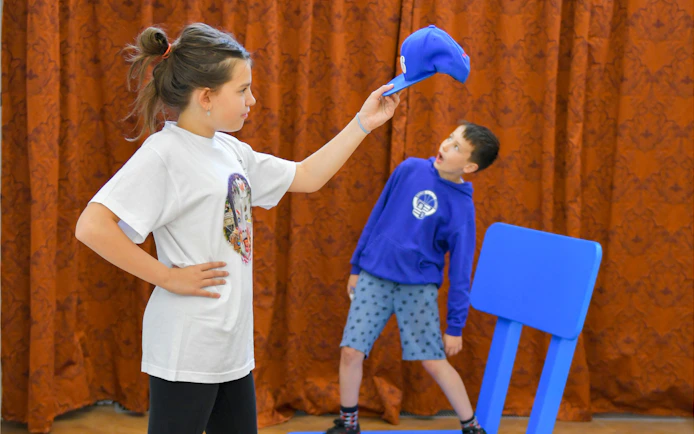 Visitors interacting with optical illusions at IAM Illusion Art Museum, Prague.