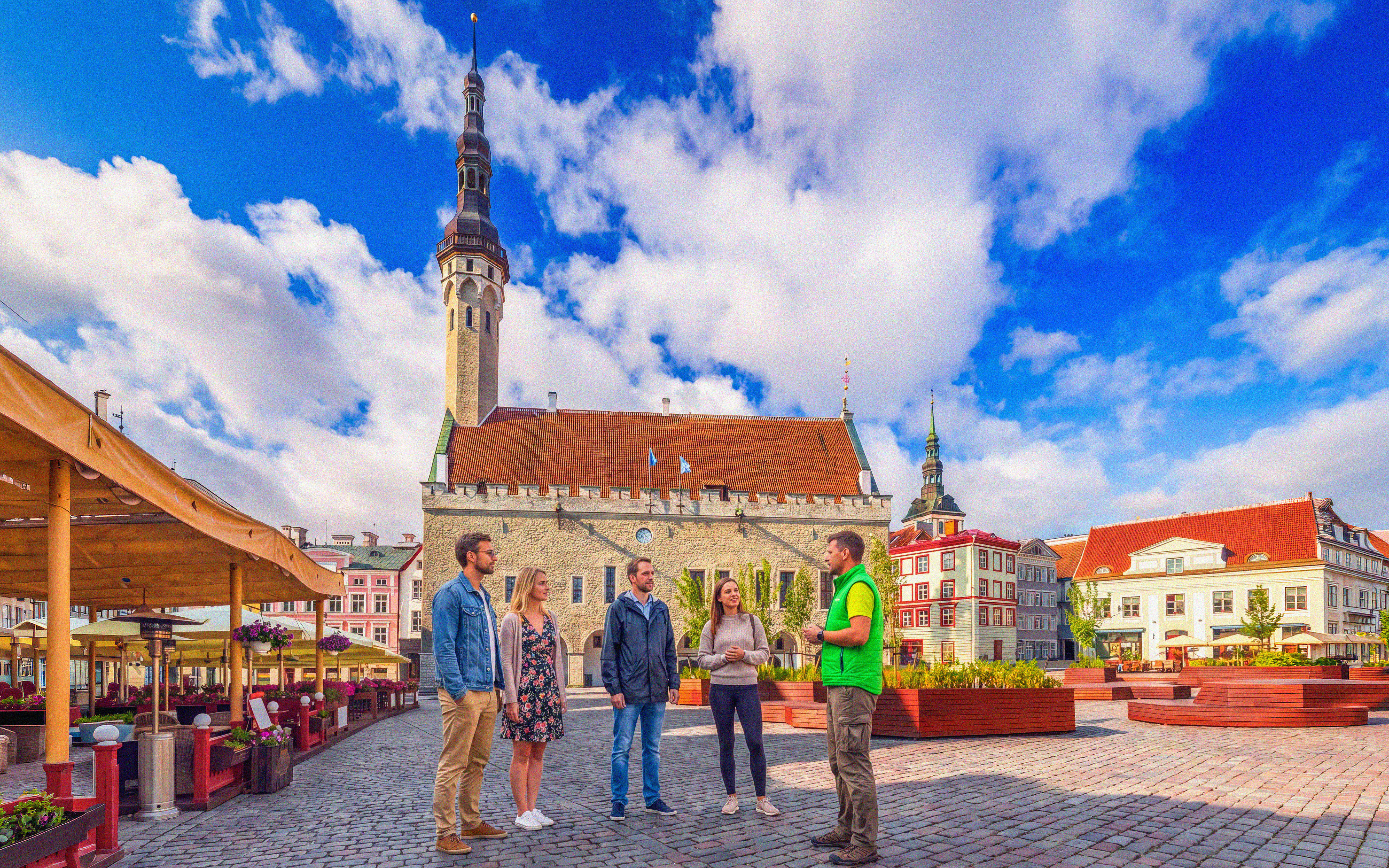 Tour group at Raekoja Plats with Tallinn Old Town Hall in background, Estonia.