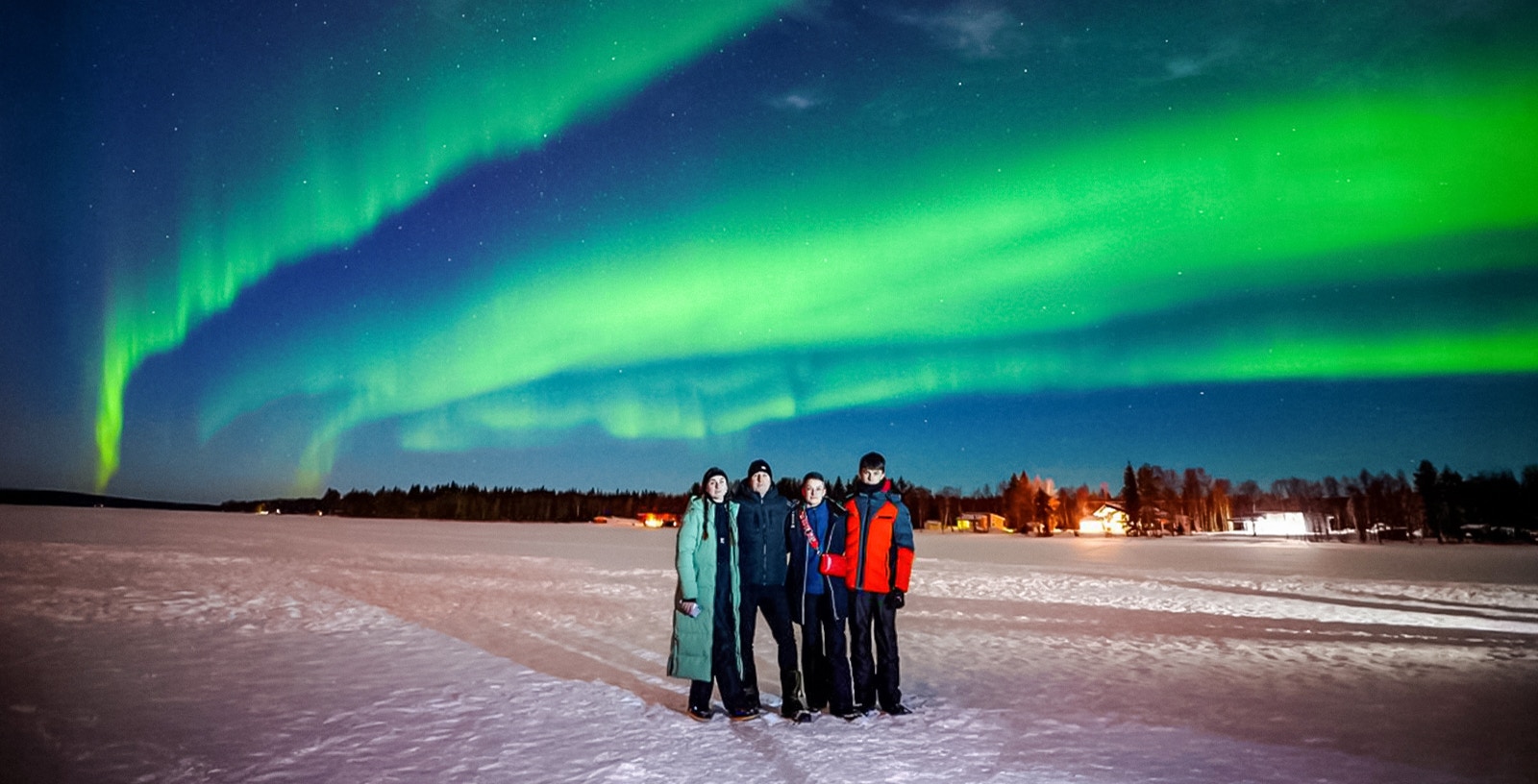 Group watching Northern Lights in Rovaniemi, Finland.