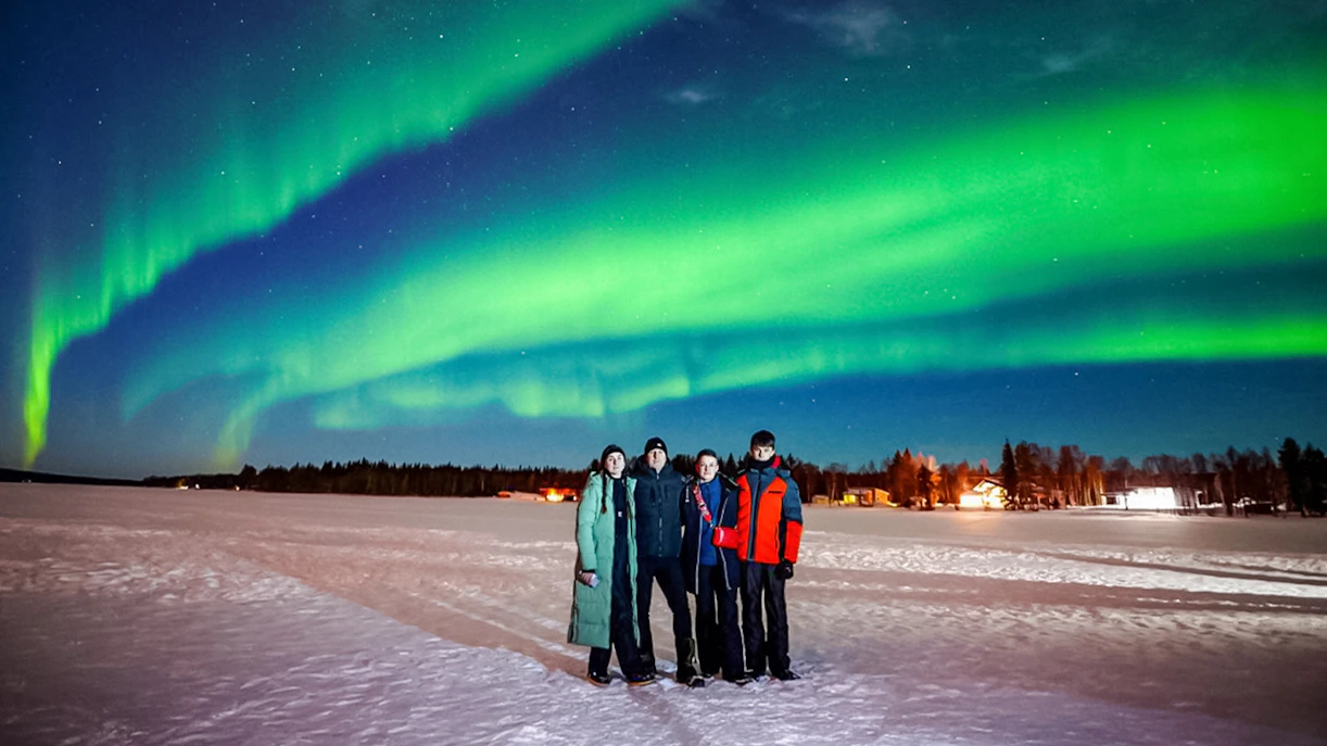 Group watching Northern Lights in Rovaniemi, Finland.