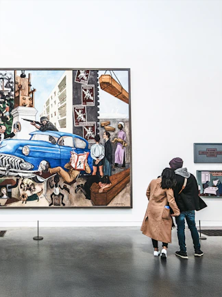 Visitors viewing a large painting at Tate Modern, London.