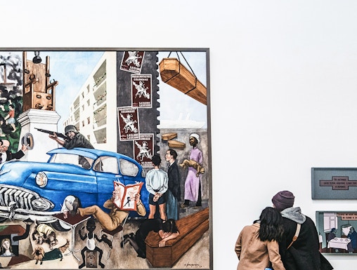 Visitors viewing a large painting at Tate Modern, London.