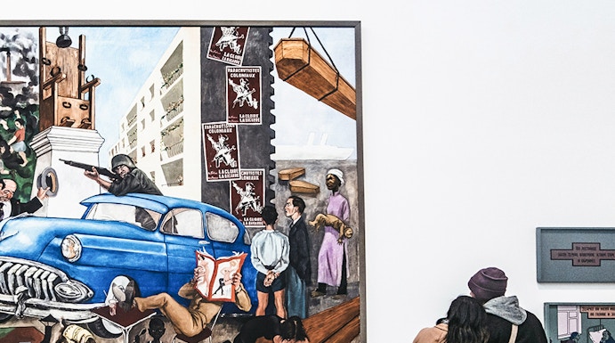 Visitors viewing a large painting at Tate Modern, London.
