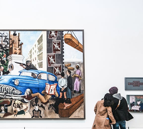 Visitors viewing a large painting at Tate Modern, London.