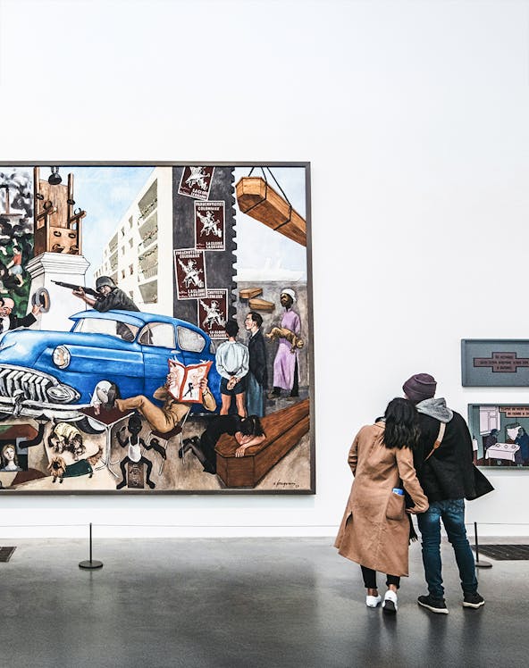 Visitors viewing a large painting at Tate Modern, London.