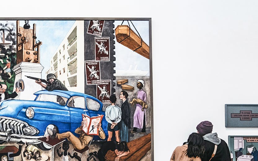 Visitors viewing a large painting at Tate Modern, London.