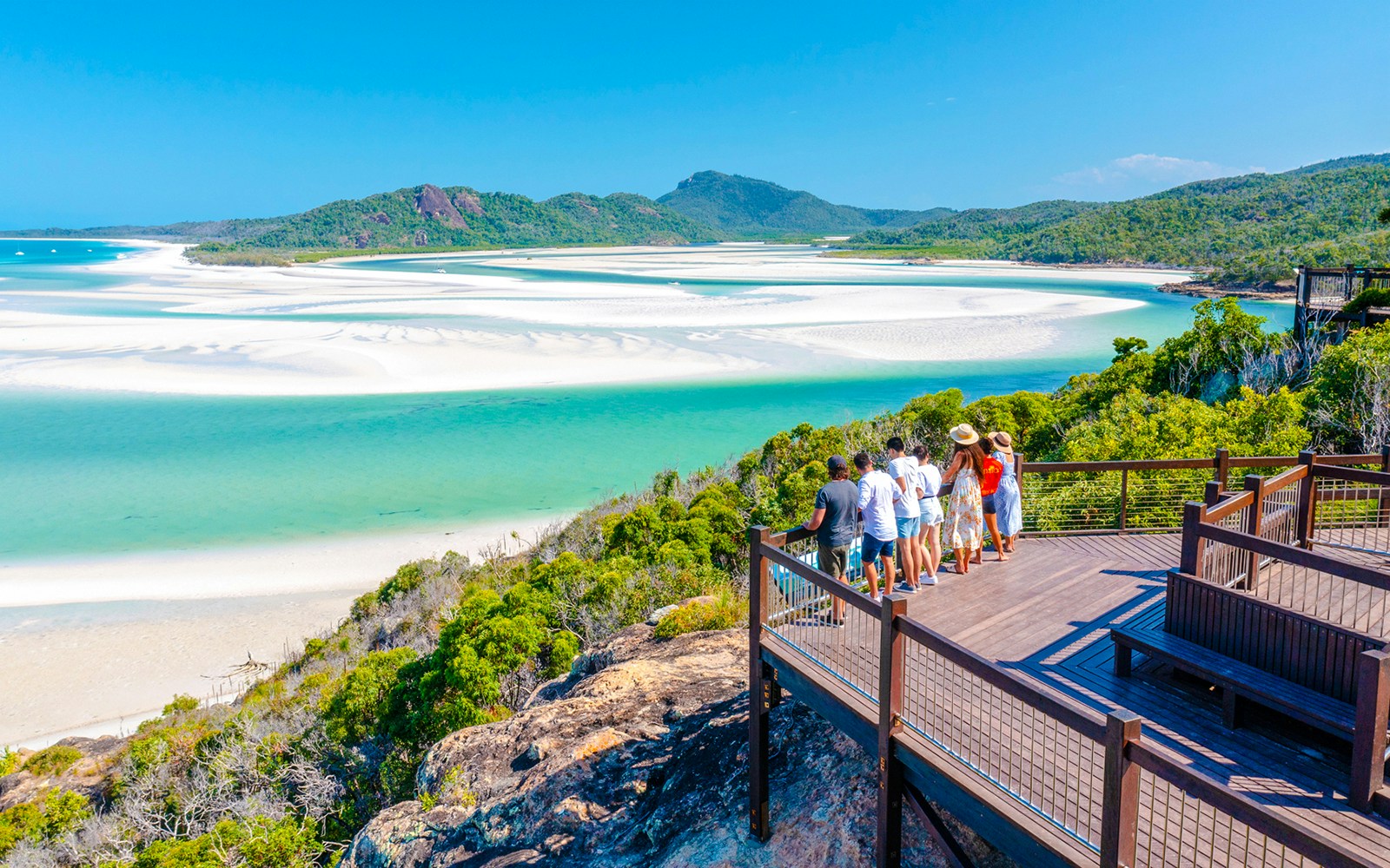 Tourists on a lookout deck viewing Whitehaven Beach's turquoise waters and sandbars, Whitsundays.