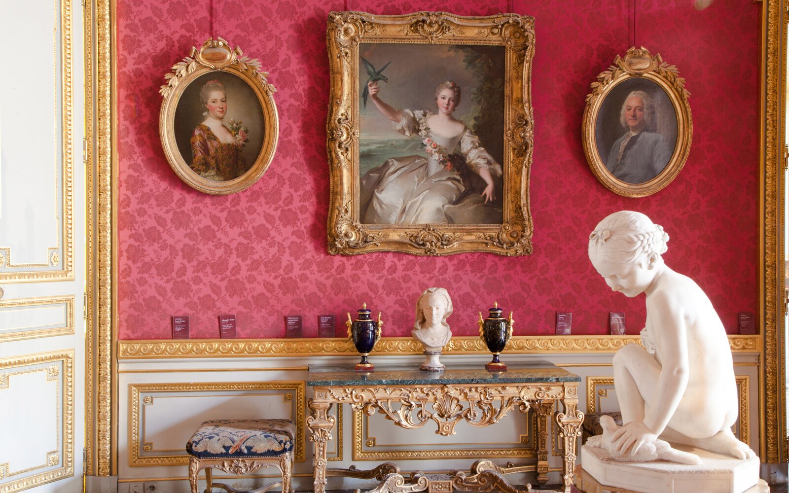 Jacquemart André Museum interior with ornate paintings and marble sculpture.