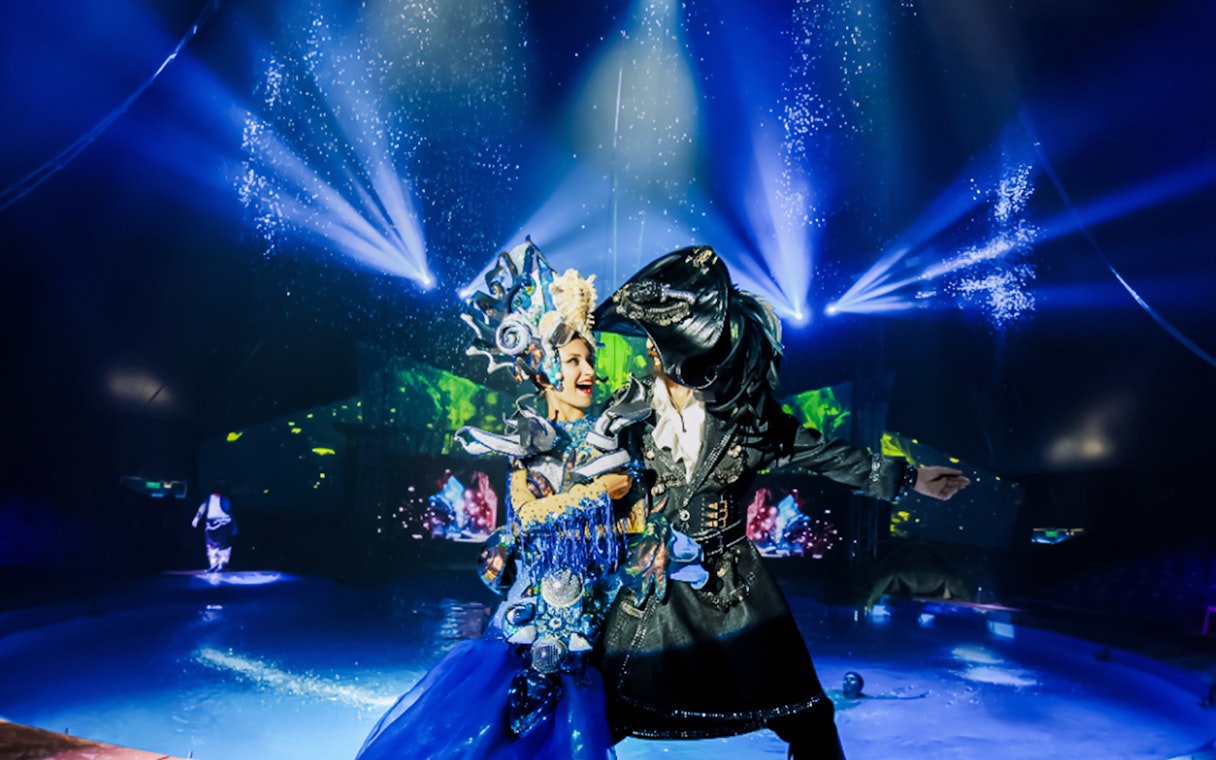 Performers in elaborate costumes at Aqua Circus Phuket show.
