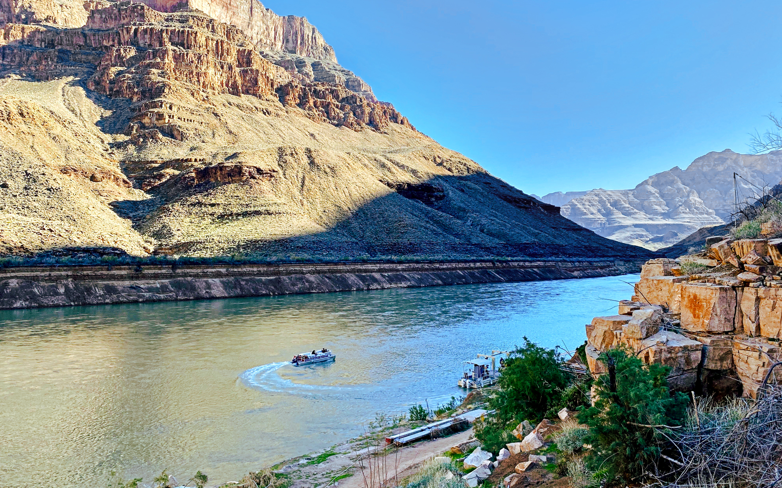 Helicopter view of Colorado River with boat at Grand Canyon West Rim.