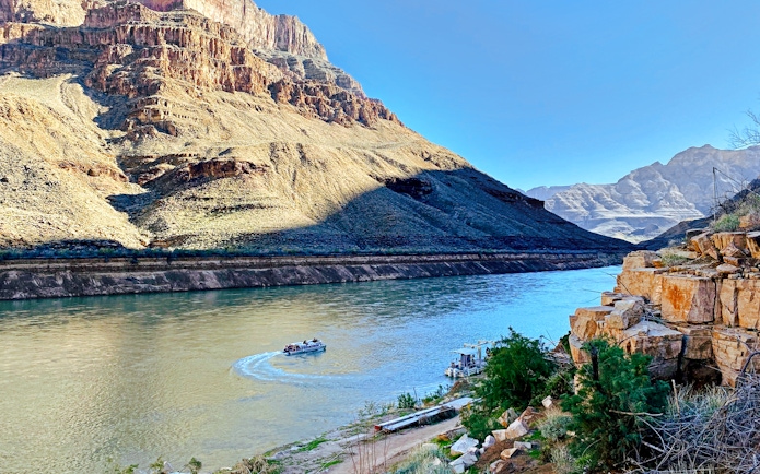 Helicopter view of Colorado River with boat at Grand Canyon West Rim.