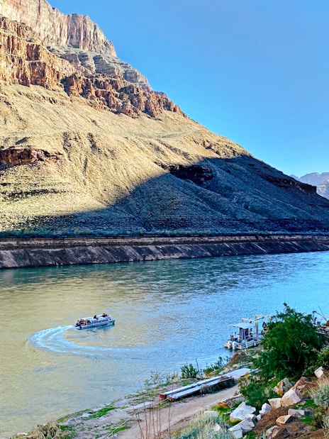 Helicopter view of Colorado River with boat at Grand Canyon West Rim.