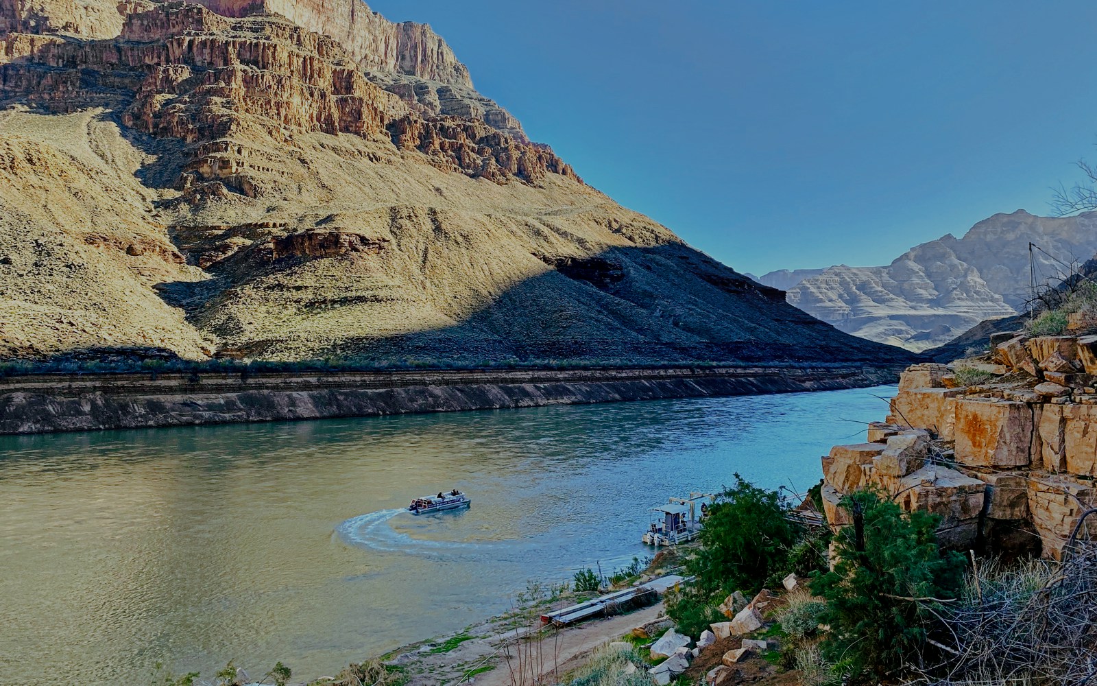 Helicopter view of Colorado River with boat at Grand Canyon West Rim.