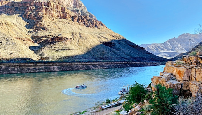Helicopter view of Colorado River with boat at Grand Canyon West Rim.