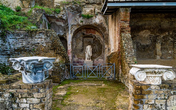 Sculpture and ancient ruins at the Archaeological Park of the Baths of Baiae.