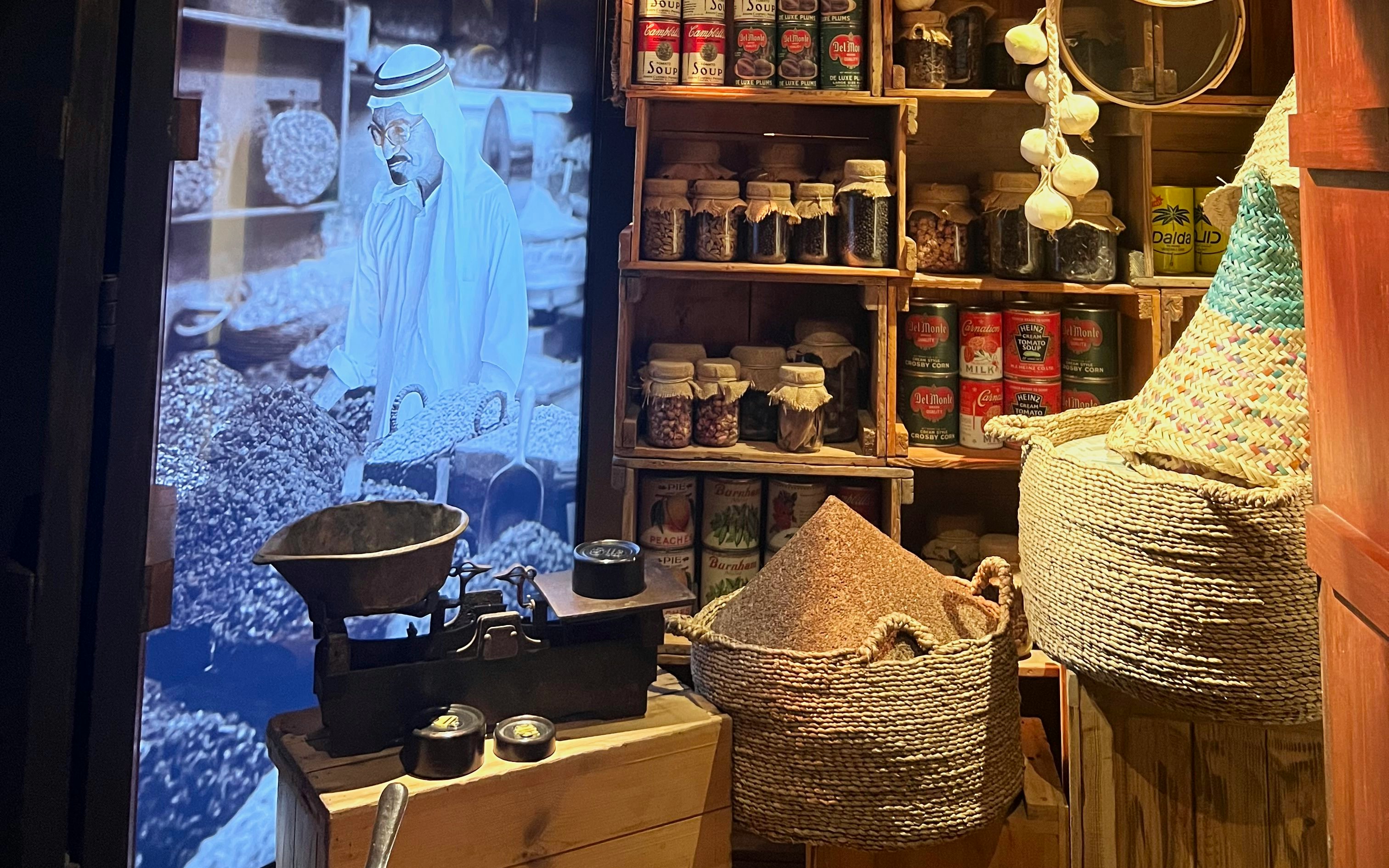 Old Dubai Gallery display with traditional market scene and spices, Dubai Frame.