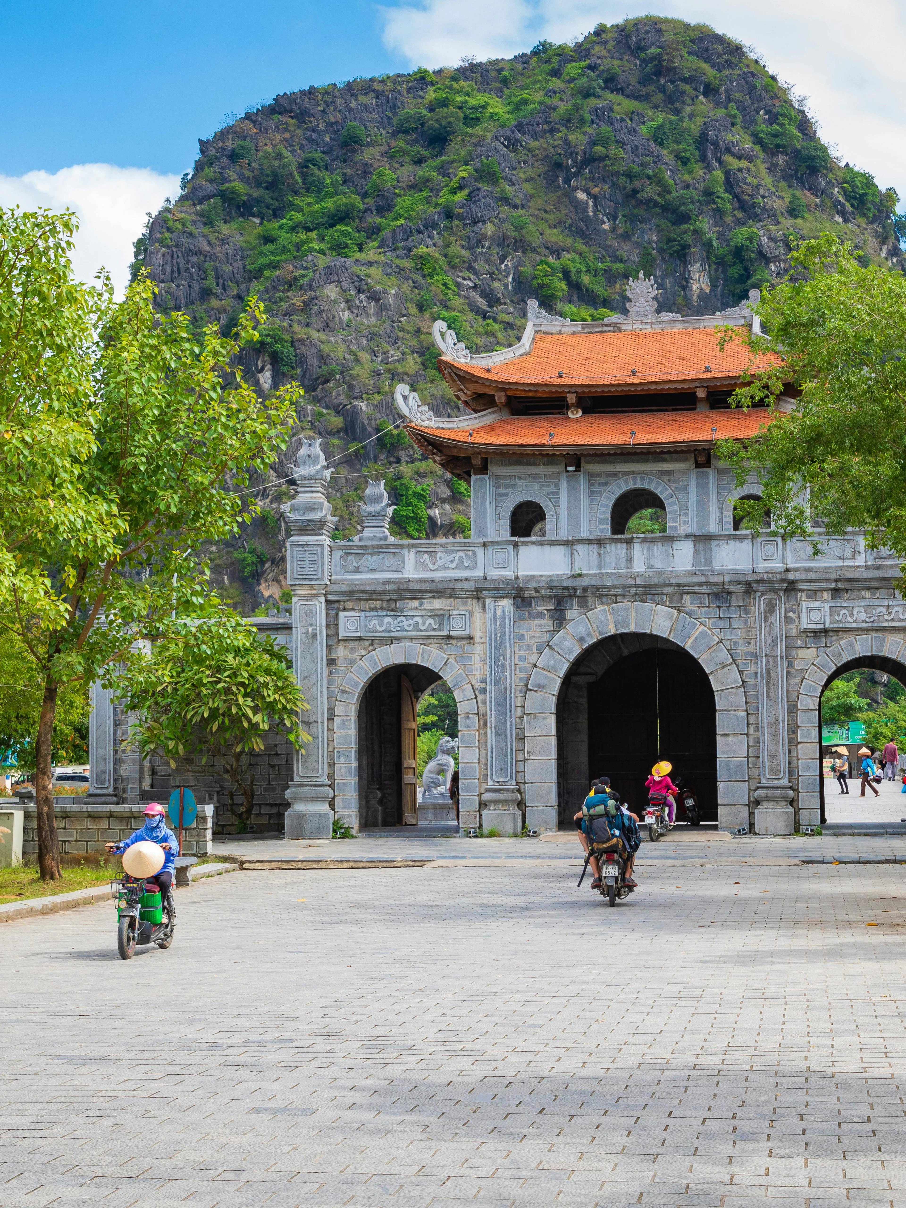 Temple of Dinh Tien Hoang entrance at Hoa Lu, Ninh Binh, with limestone mountains in the background.