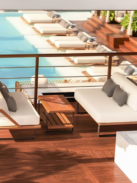 Sunset terrace with poolside lounge at Yona Beach Club, Phuket.