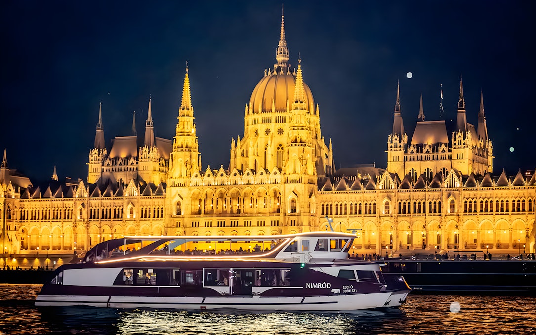Valentine's Day dinner cruise with piano show on the Danube River, Budapest Parliament illuminated at night.