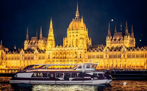 Valentine's Day dinner cruise with piano show on the Danube River, Budapest Parliament illuminated at night.