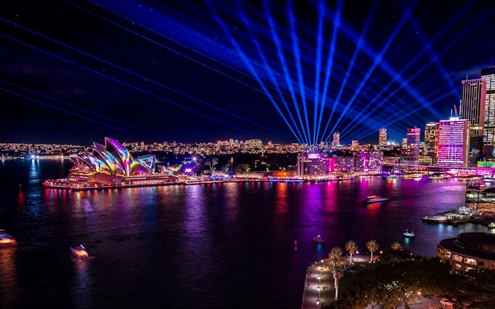 Sydney Opera House illuminated during Vivid Sydney festival on a Premium Vivid Cruise.