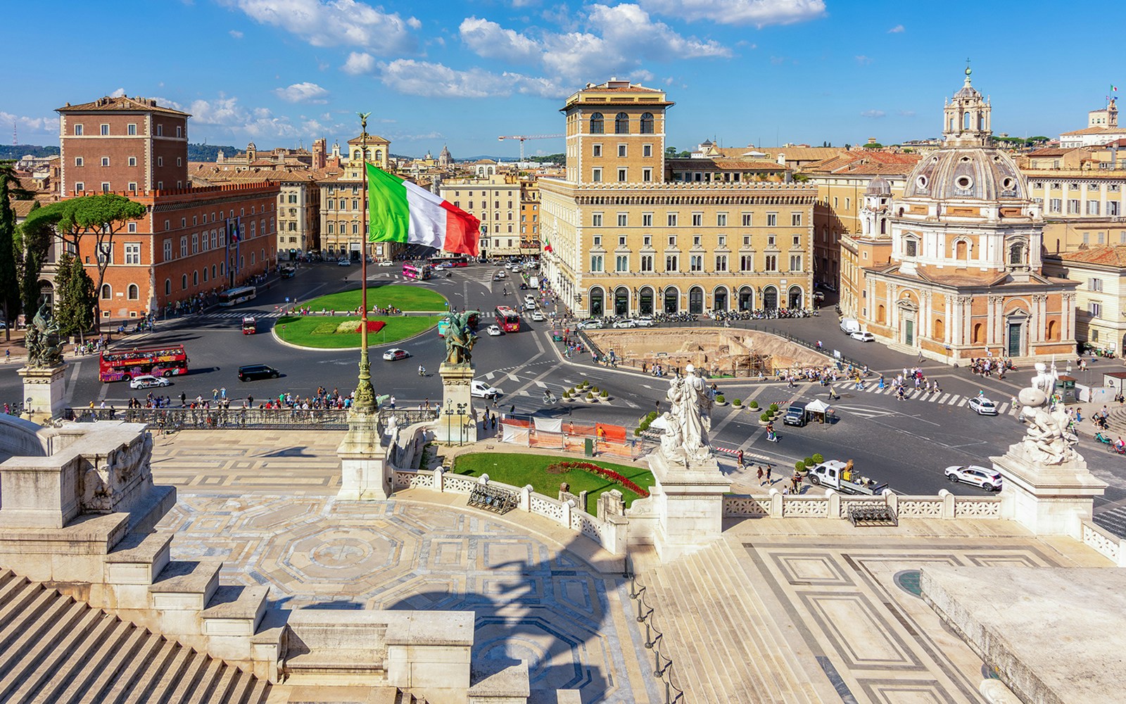 Venice square view from Altare della Patria, Rome, with Italian flag and historic buildings.