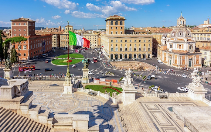 Venice square view from Altare della Patria, Rome, with Italian flag and historic buildings.