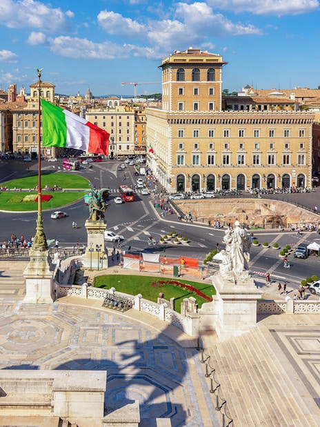 Venice square view from Altare della Patria, Rome, with Italian flag and historic buildings.