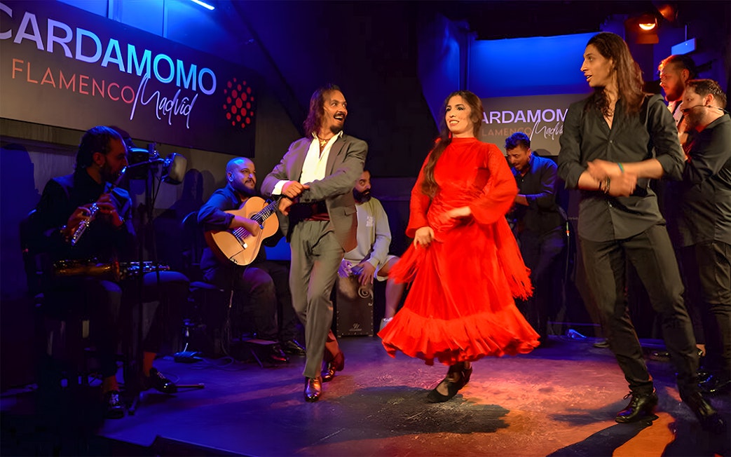 Flamenco dancers performing at Cardamomo in Madrid with musicians on stage.