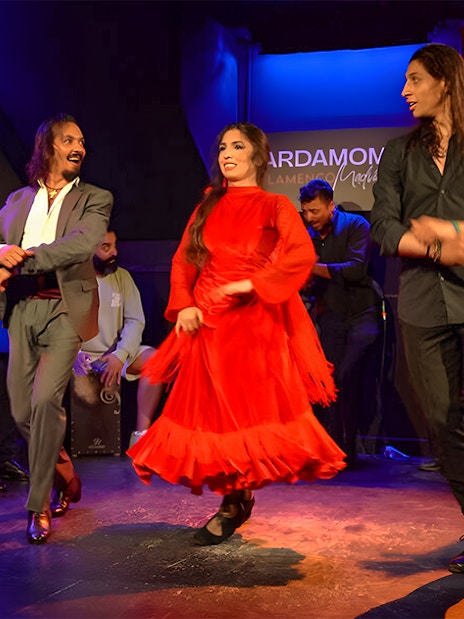 Flamenco dancers performing at Cardamomo in Madrid with musicians on stage.
