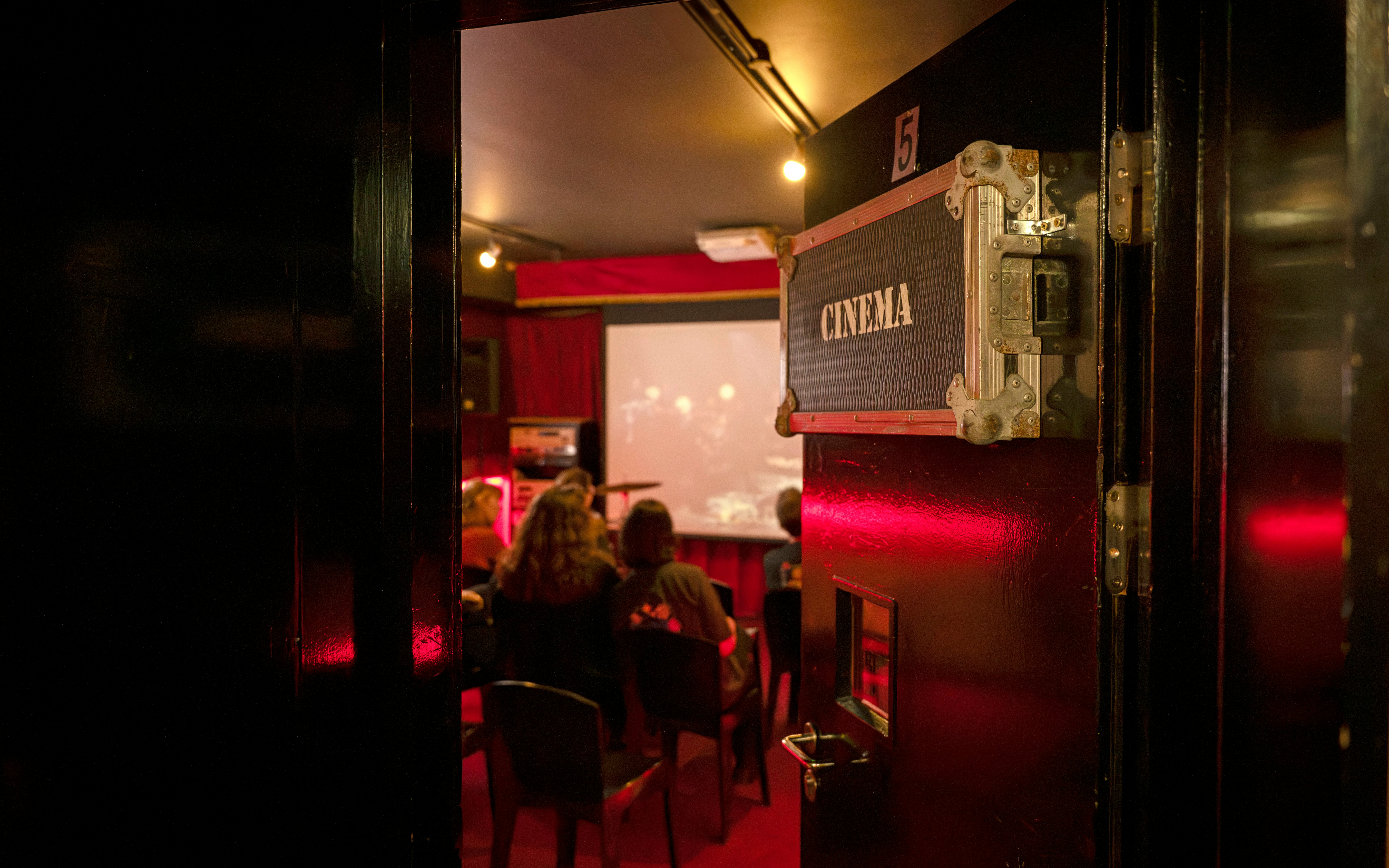 Cinema room at Irish Rock & Roll Museum with audience watching a film.