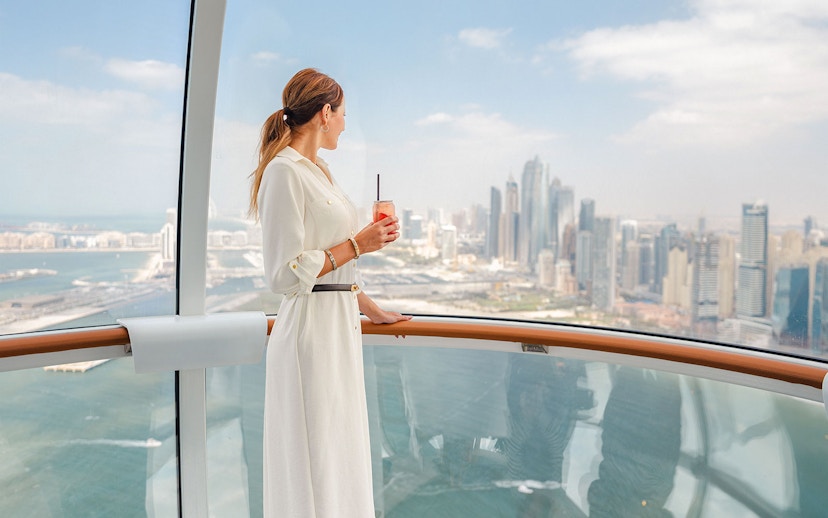 Visitor enjoying city skyline view from inside Ain Dubai.
