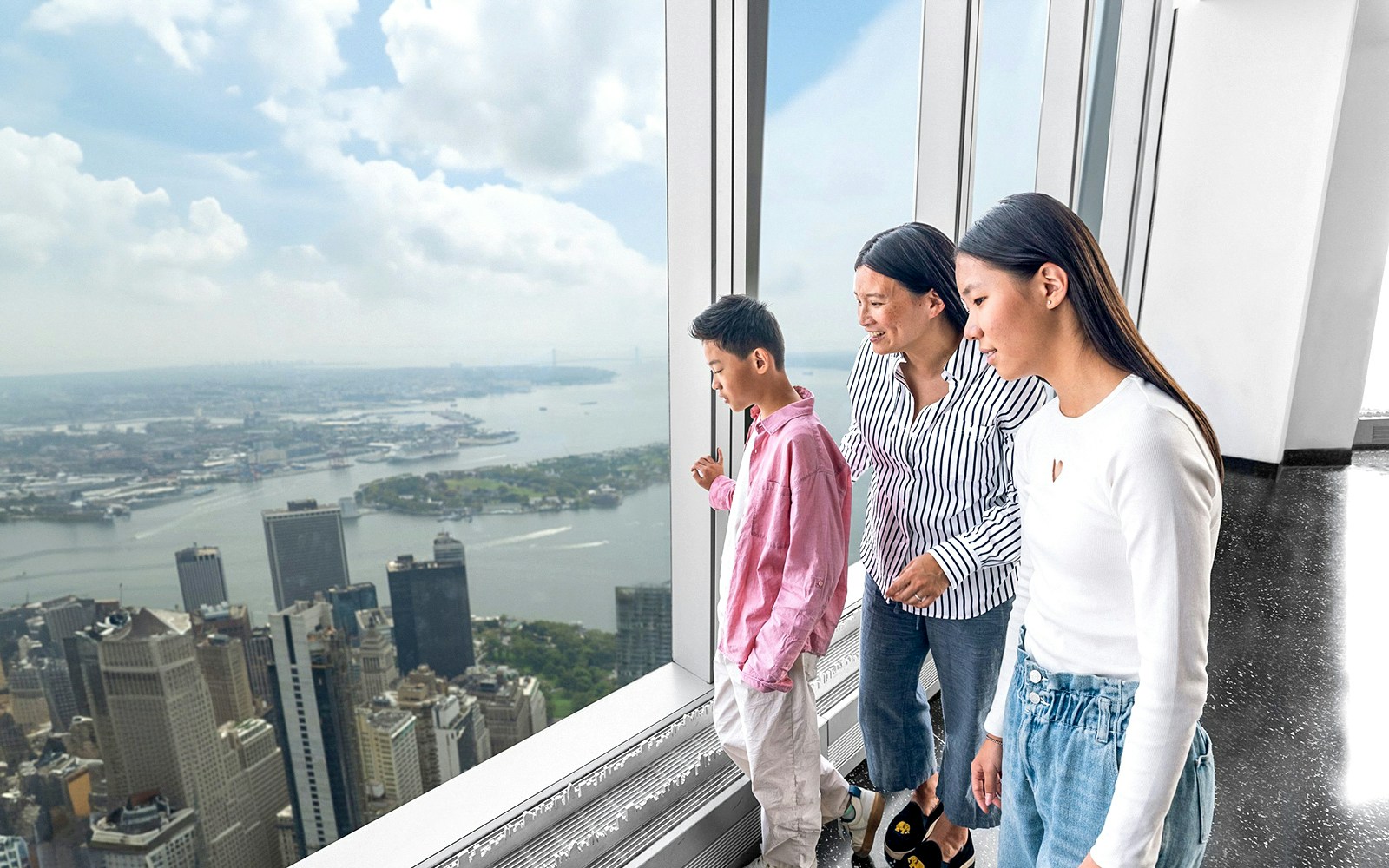 Visitors enjoying New York skyline view from One World Observatory.